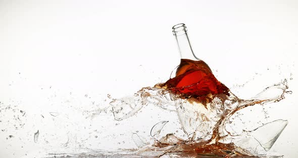 900134 Bottle of Pink Wine Breaking and Splashing against White Background, Slow motion 4K