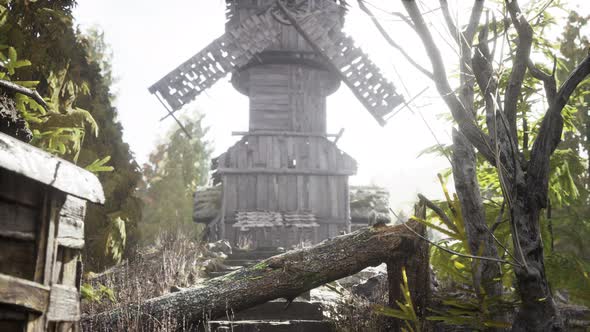 Old Traditional Wooden Windmill in the Forest alt
