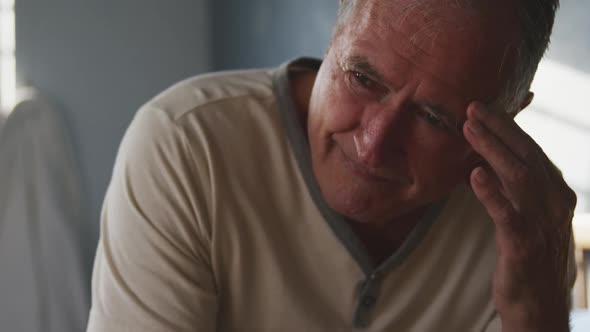 Senior man lying on bed at home