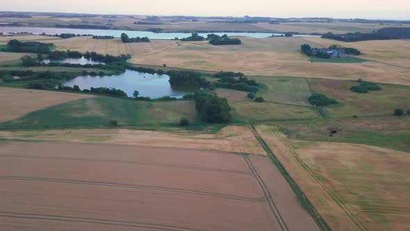 Scenic Aerial Shot of Brown Fields With View of the Lake