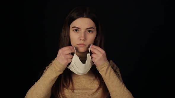 Confident Young Girl Wearing a Medical Mask Putting on a Medical Protective Mask. Coronavirus. COVID