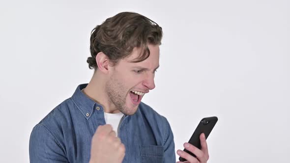 Young Man Celebrating on Smartphone Success on White Background