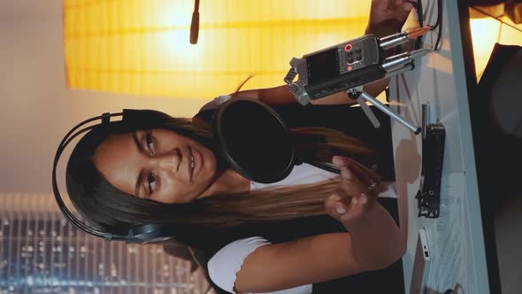 Multiracial Female Journalist Doing Online Interview on the Computer in Home Recording Studio