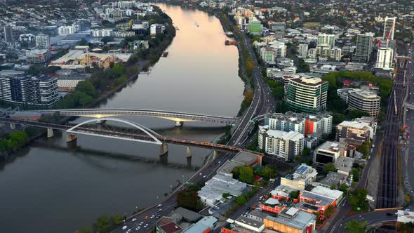 Aerial View Of Train Crossing The Merivale Bridge Over Brisbane River In Australia - drone shot