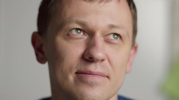 Young Man with Gray Eyes Smiling Closeup