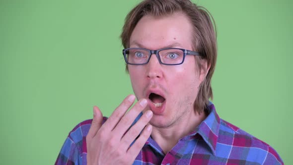 Face of Young Handsome Hipster Man Looking Shocked