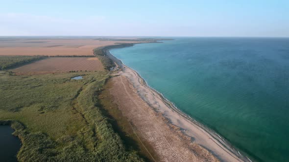 Aerial fly over beautiful empty endless wild beach