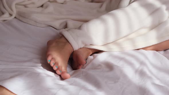 Girl Sleeping in Bed Legs Top View