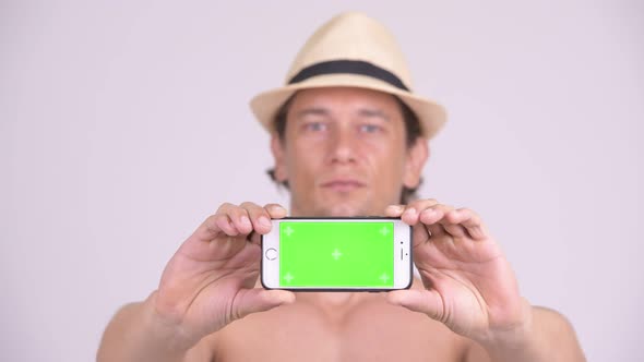 Face of Happy Muscular Tourist Man Showing Phone Shirtless