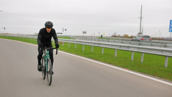 The Athlete is Training on a Bicycle