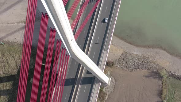 Vehicles Crossing a Cable Stayed Suspension Bridge Crossing a River