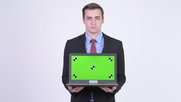 Young Happy Handsome Businessman Showing Laptop