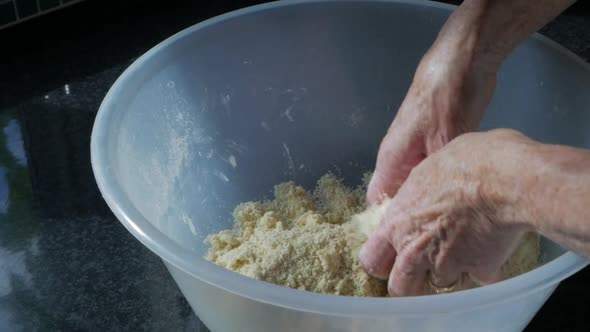 Woman mixing butter and flour in a large mixing bowl to make pastry - Slow Motion 60fps
