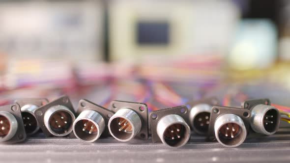 Slider Shot Video of Blurry Metal Sockets for Plugs