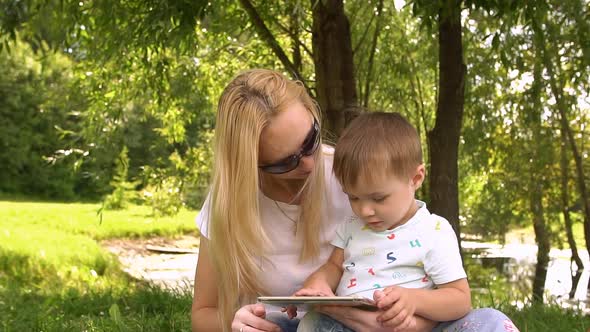 Woman and Child Using Tablet Computer