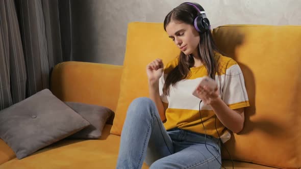 Girl Listens To Music on Smartphone