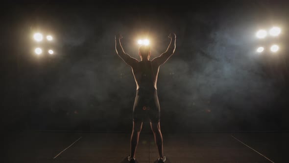 A Man is Dressing in Tights is Standing on the Stage