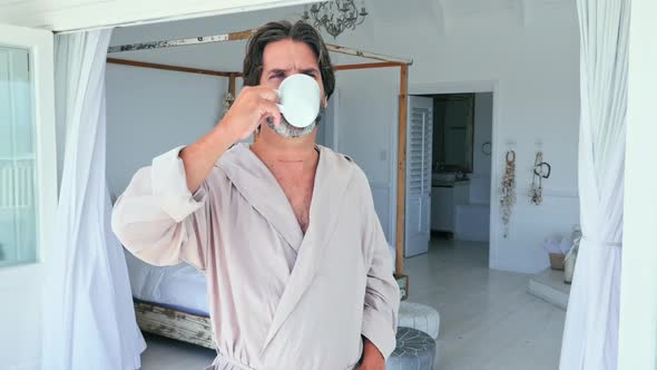 Man drinking coffee on patio