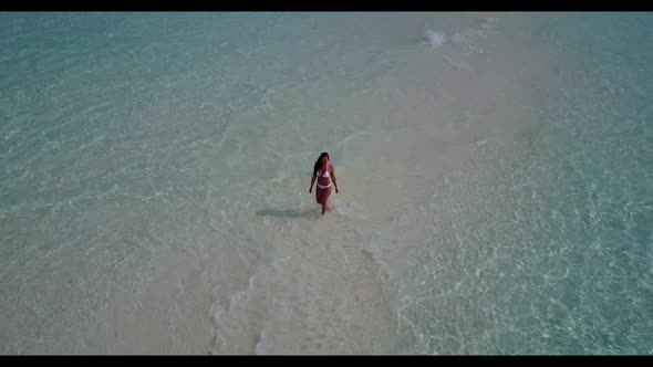 Lady alone tanning on idyllic coast beach wildlife by turquoise lagoon with clean sand background of