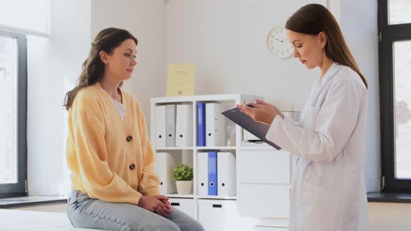 Female Doctor and Woman with Sore Arm at Hospital