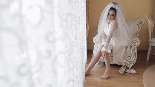 Beautiful and Lovely Bride in Night Gown and Veil. Wedding Morning. Slow Motion