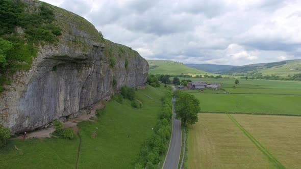 Aerial view of a man rock climbing up a mountain