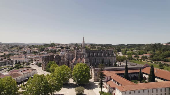 Batalha Monastery on sunny day in Portugal. Aerial orbit