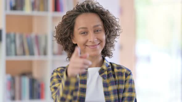 Portrait of Mixed Race Woman Pointing and Inviting