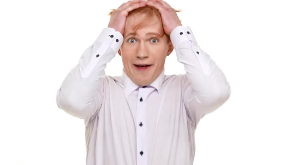 Young Frighten Redhead Caucasian Man Standing Scared on White Background in Slowmotion