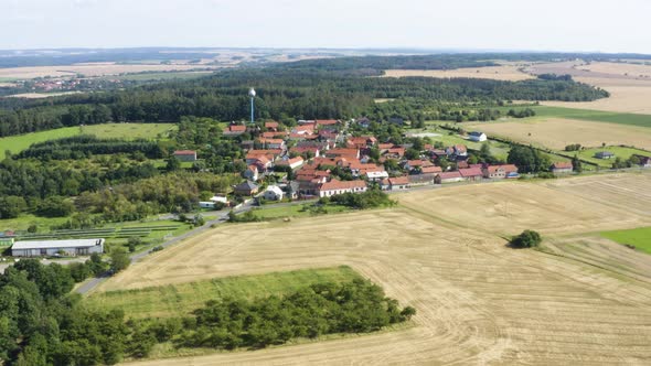 Aerial Drone Shot  a Town Surrounded By Fields and Forests in a Rural Area