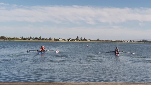 Four senior caucasian men and women rowing boat on a river