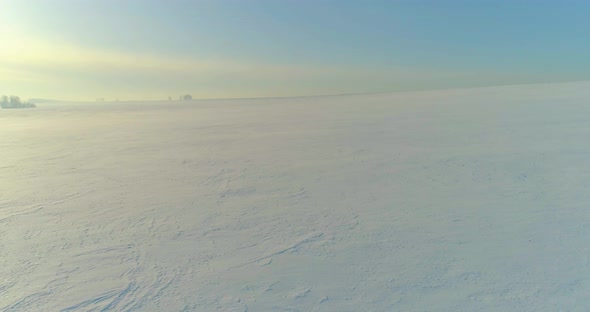 Aerial View of Cold Winter Landscape Arctic Field Trees Covered with Frost Snow Ice River and Sun