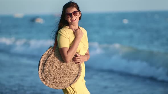 Happy Tourist Woman Posing on Beach at Sunset Relaxing Having Fun