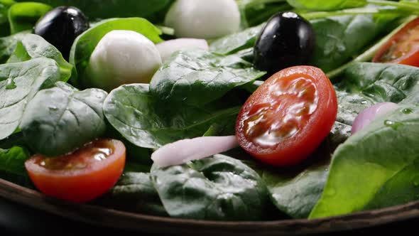 Cherry tomato falling down in fresh salad