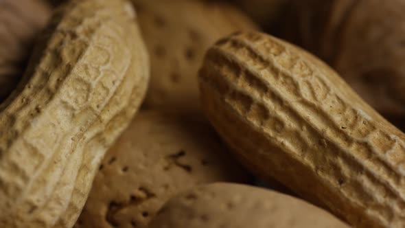 Cinematic, rotating shot of a variety of nuts on a white surface - NUTS MIXED