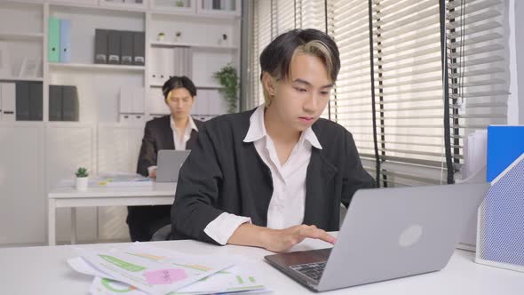Asian handsome businessman gay people working in office with happiness.