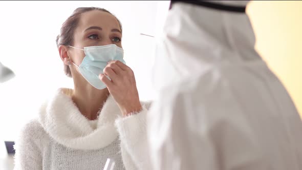 Doctor in Protective Suit Takes Swab From Nose of Patient at Home