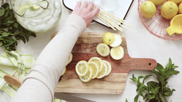 Sliced organic lemon on wood cutting board.