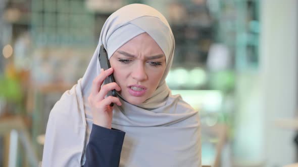 Portrait of Angry Arab Woman Talking on Smartphone 