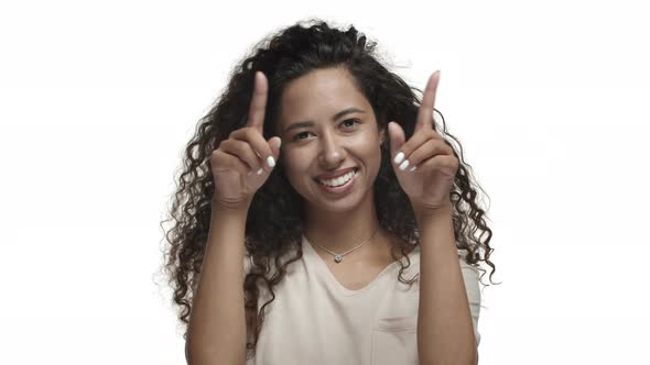 Closeup of Beautiful Darkskinned Girl with Curly Long Hair Wearing Beige Tshirt Express Love Showing