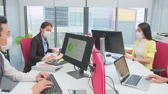 Group of Asian team business people man and woman wear face mask, working and meeting in office.