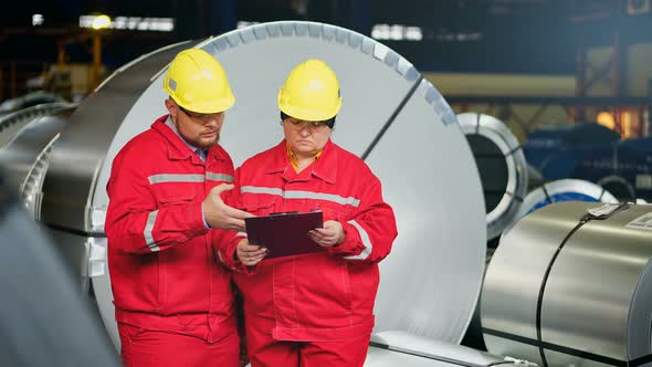 Team of Engineers Having Discussion on Industrial Steel Plant