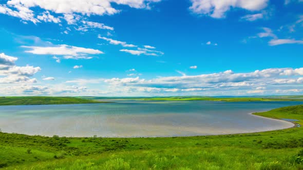 White Fluffy Clouds over the Lake