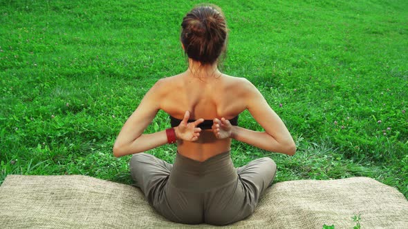 Girl Is Siiting in the Yoga Mat and Doing One of the Yoga Poses