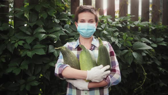 Young Female Farmer Holds a Harvest in Hands