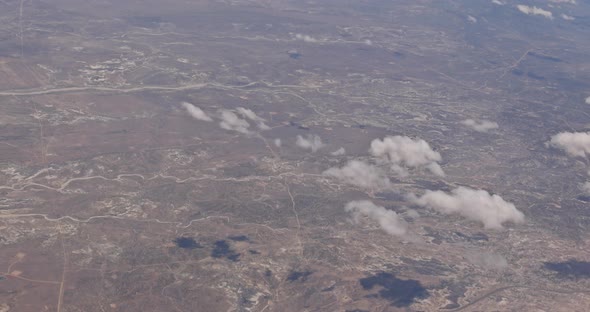 The View From the Plane of Fluffy Clouds in Desert Mountains From an Airplane New Mexico USA