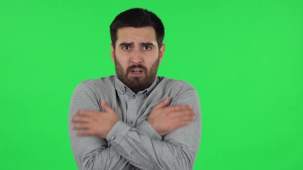 Portrait of Brunette Guy Froze and Trying To Keep Warm. Green Screen