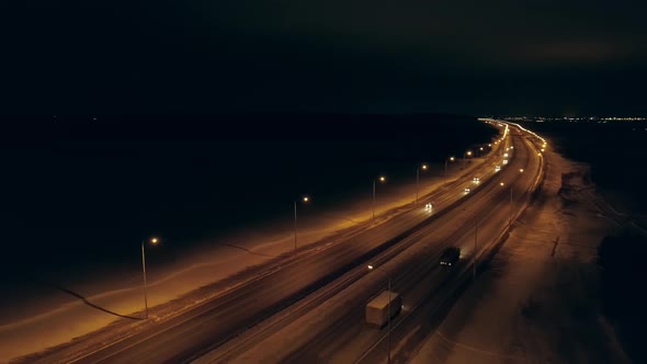 Aerial view of winter night highway with orange lanterns 02