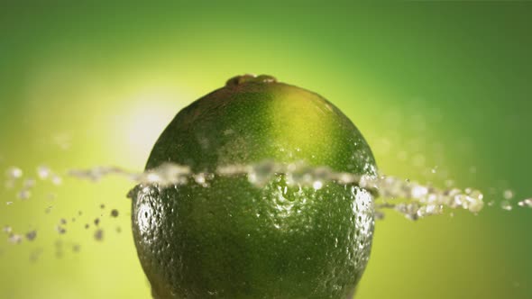 Half Lime Falling and Splashing on Green Background