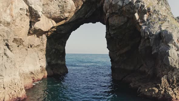 Stone Archway in Gaztelugatxe with Deep Blue Ocean Horizon and Blue Sky